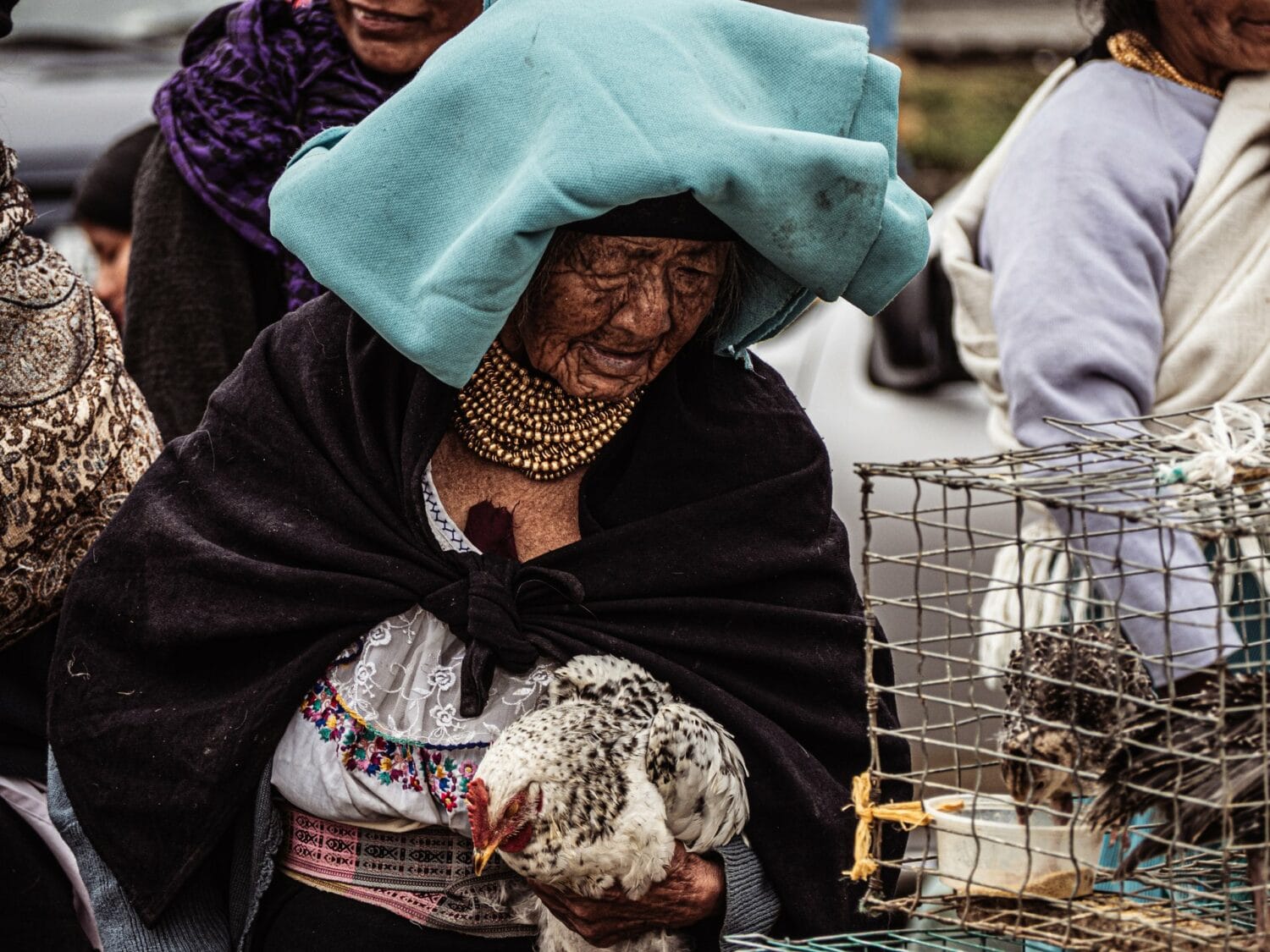 Femme portant une poule au marché aux animaux d’Otavalo