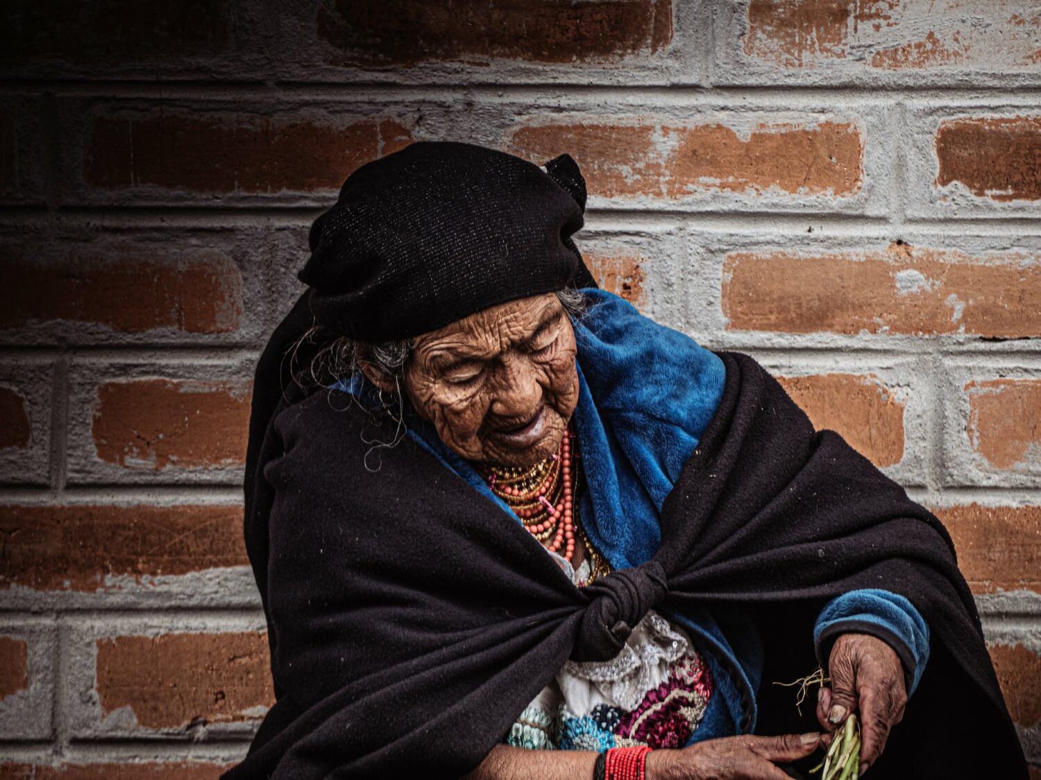 Vieille femme otavaleña en tenue traditionnelle à Otavalo